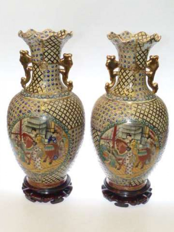 Pair of Oriental pottery vases decorated with oval panels on wood stands