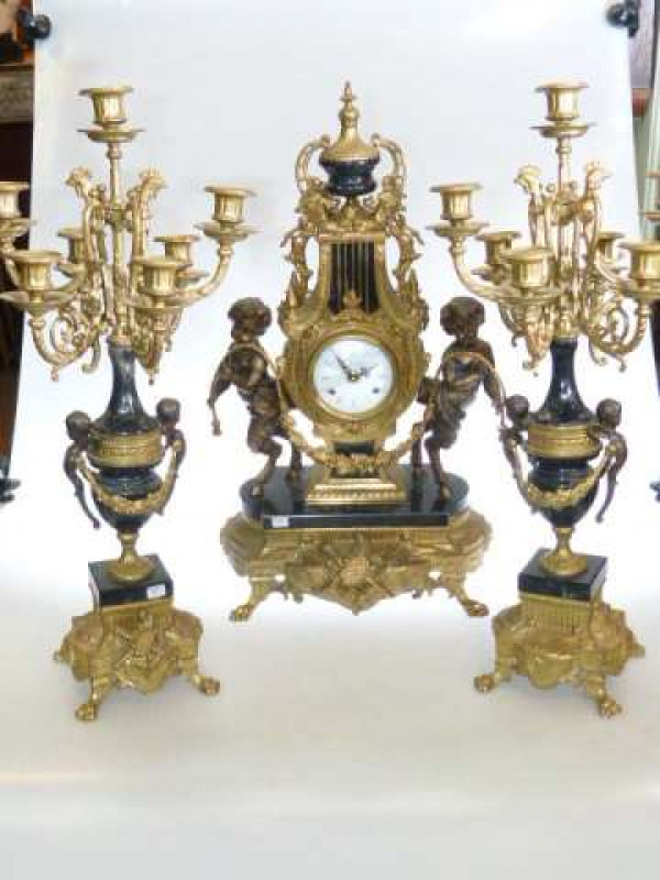 Highly ornate gilt and marble clock garniture decorated with spelter cherubs