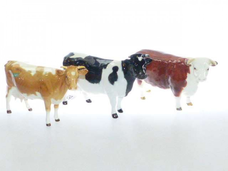 Beswick model of a Hereford cow, no. 1360; Beswick model of a Guernsey cow, no. 1248A; and a Beswick model of a fresian cow, no. 1362A (3)
