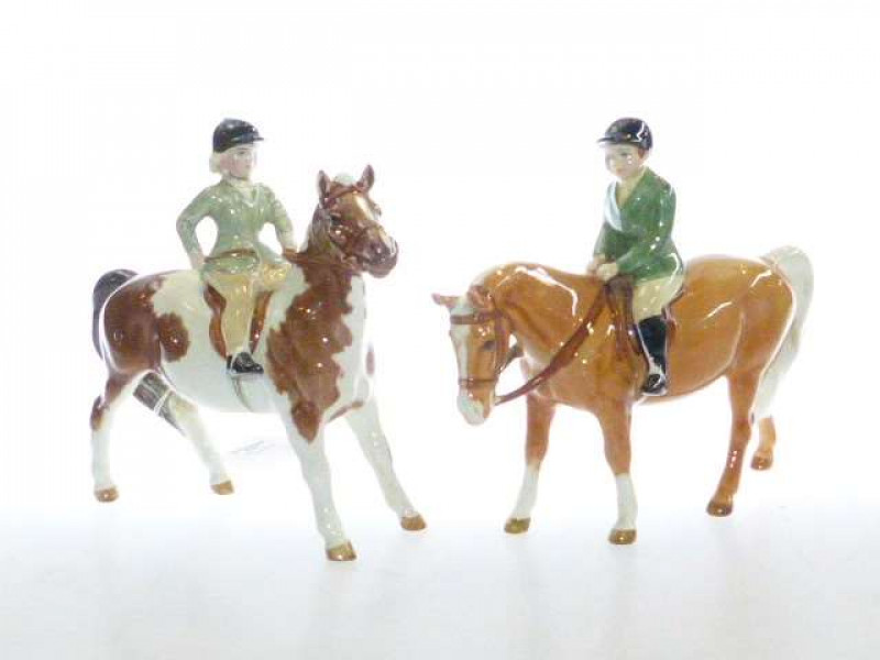 Beswick model of a boy on pony, no. 1500, palomino; and a Beswick model of a girl on pony, no. 1499, skewbald (2)