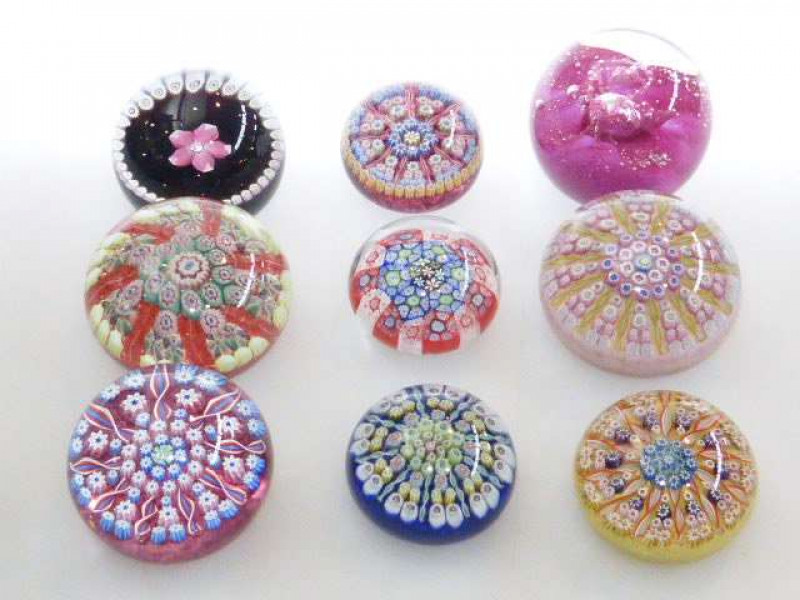 Collection of nine paperweights including John Deacon