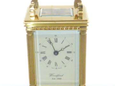 Period style brass carriage clock, signed Woodford, with key and card...