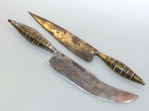 Two antique daggers, each handle embellished with mixed metals