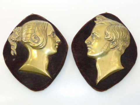 Pair of brass portrait plaques of Victoria and Albert, c.1840, each mounted...