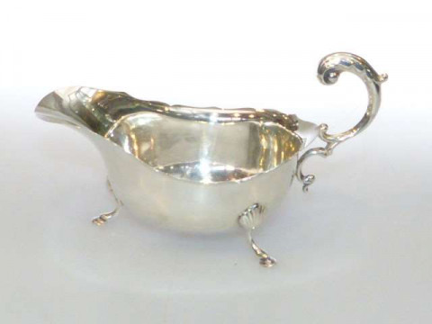 Silver sauce boat with scroll handle