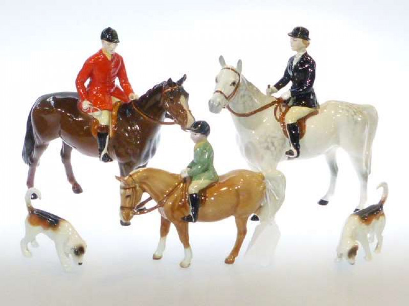 Beswick model of a Huntswoman, no, 1730, grey; Beswick model of a Huntsman, no. 1501, brown; Beswick model of a boy on pony, no. 1500, palomino; and two Beswick hounds (5)