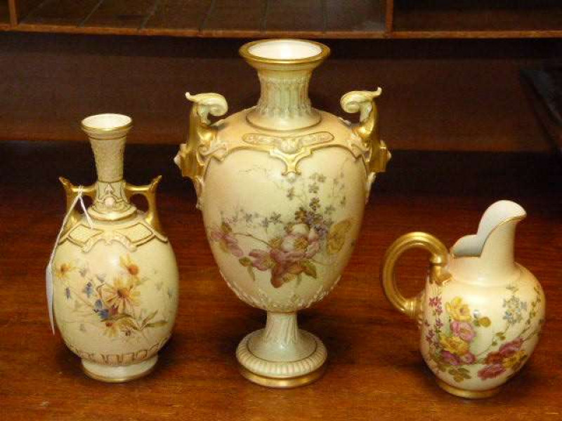 Three pieces of Royal Worcester blush ivory including two vases and a flat back jug