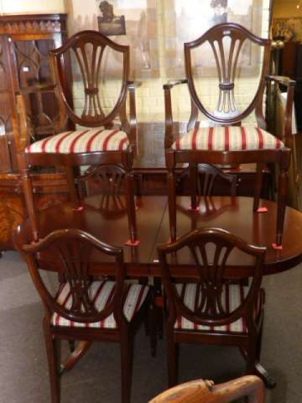 Strongbow mahogany three door sideboard, twin pedestal extending dining table and six Hepplewhite style dining chairs