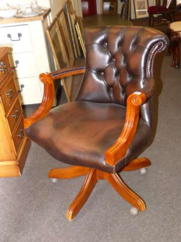 Brown buttoned leather swivel desk chair