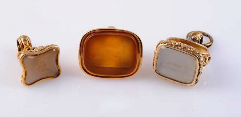 A COLLECTION OF SIX 19TH CENTURY FOBS Comprising three set with a citrine and three with carved agate seals, two of which depict a greyhound. (6) Gross 59 grams