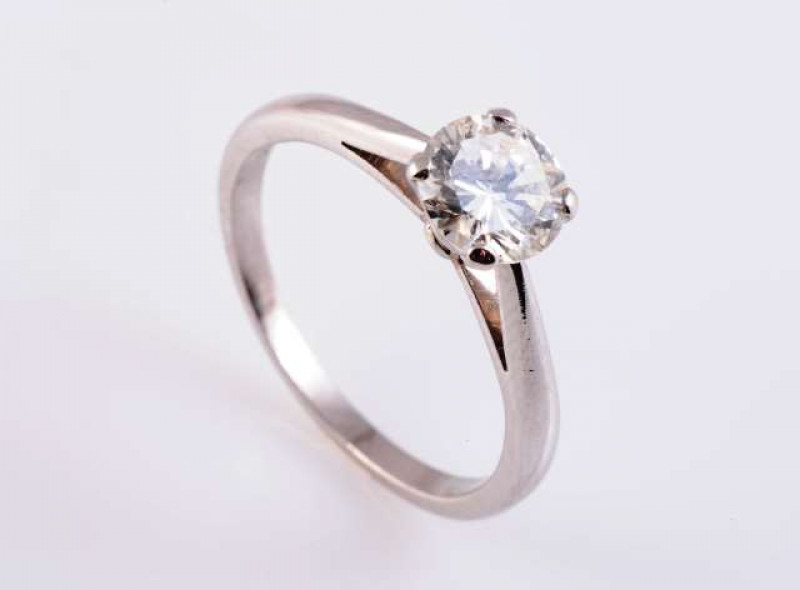 A SINGLE STONE DIAMOND RING The brilliant cut diamond four claw set in a simple pierced mount between open tapering shoulders on a plain band. Ring size Q 1/2 Weight approximately 5gms.