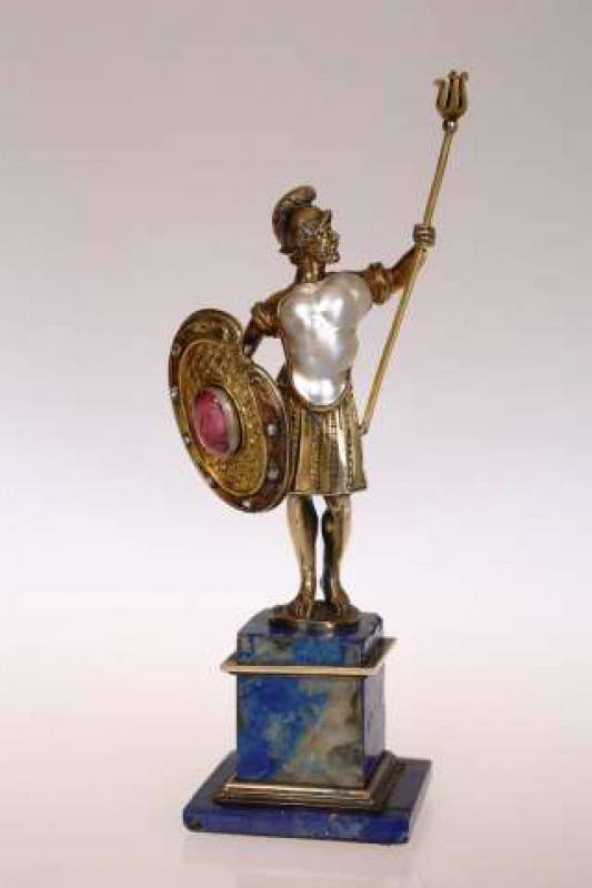 A FINE 19TH CENTURY JEWELLED FIGURE OF A ROMAN WARRIOR With pearl inset forming his torso, holding a trident in his raised arm, in his right hand a shield with central pink topaz and diamond surround, mounted on a lapis lazuli pedestal. 13cm