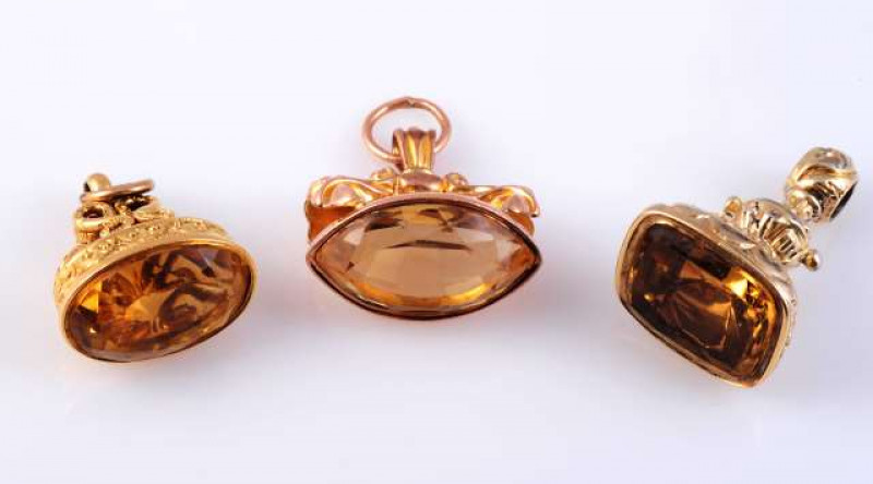 A COLLECTION OF SIX 19TH CENTURY FOBS Comprising three set with a citrine and three with carved agate seals, two of which depict a greyhound. (6) Gross 59 grams