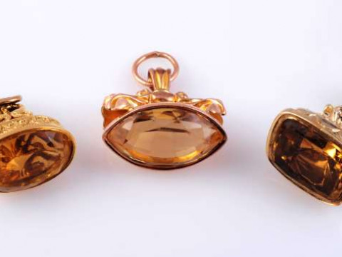 A COLLECTION OF SIX 19TH CENTURY FOBS Comprising three set with a citrine and three with carved agate seals, two of which depict a greyhound. (6) Gross 59 grams thumbnail