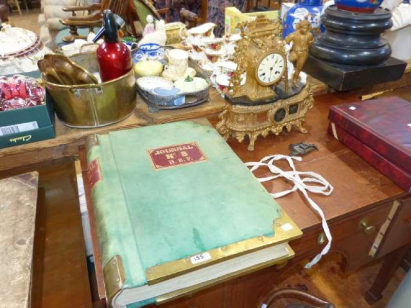 Heavy brass bound shipping journal, written up in French, together with ornate gilt clock (2)