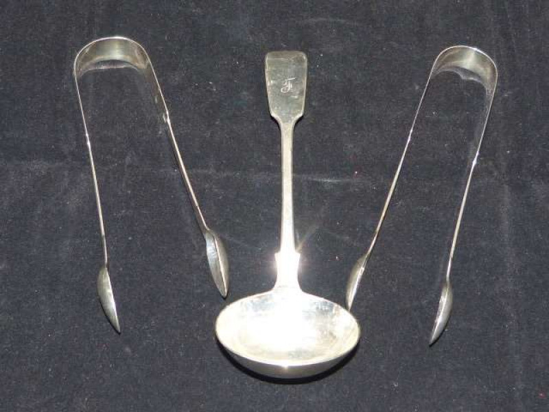 Silver sauce ladle, London 1877; Pair of silver sugar tongs, Exeter 1846; and another pair of silver sugar tongs, London 1841 (3) 4oz