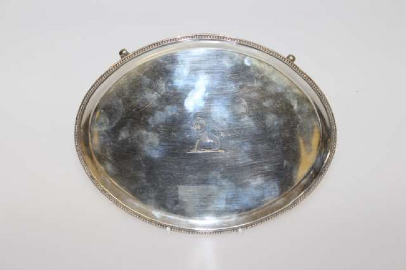 A GEORGE III SILVER TEAPOT STAND, Hester Bateman, London 1788, oval with beaded rim, raised on tapering beaded feet. 7.9oz, 20.5cm by 16cm