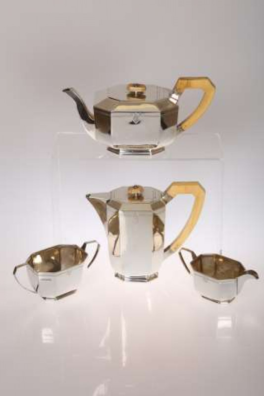 AN ART DECO SILVER FOUR-PIECE TEA SERVICE, Emil Viner, Sheffield 1938, comprising teapot, hot water pot, sugar bowl and cream jug, the teapot and hot water jug with ivory handle and knop. Gross 55oz