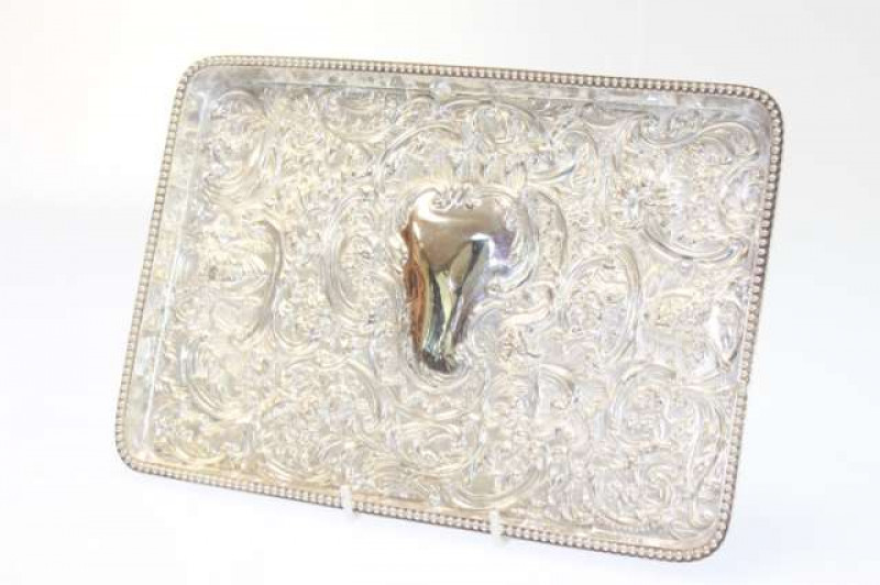 A FINE VICTORIAN SILVER DRESSING TABLE TRAY, William Comyns, London 1899, rectangular with beaded gallery, embossed with masks, scrolls and acanthus in Rococo style. 10.8oz, 27cm by 18.5cm