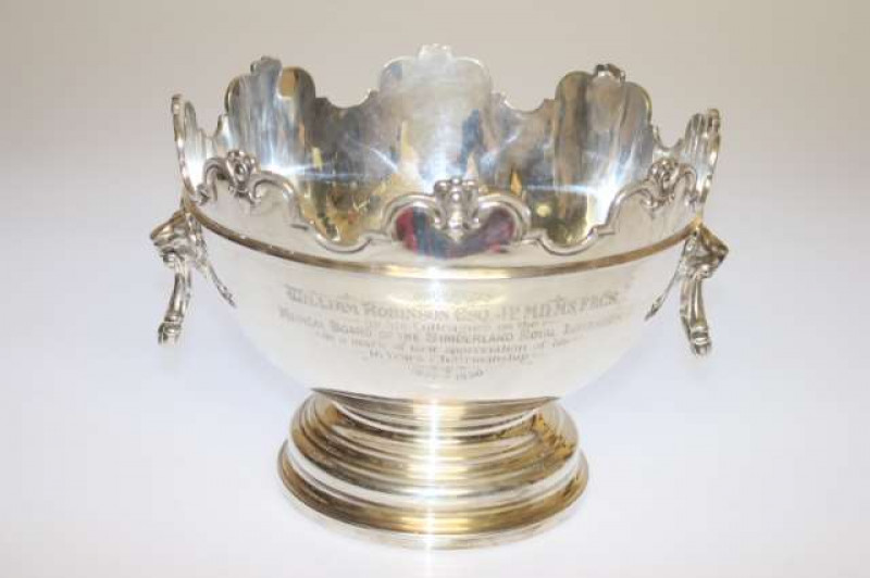 A SILVER PUNCH BOWL, Atkin Bros, Sheffield 1926, with lion-mask handles and shaped rim, raised on a stepped and domed foot, engraved with presentation inscription. 57oz, 20.5cm by 31cm (across handles)