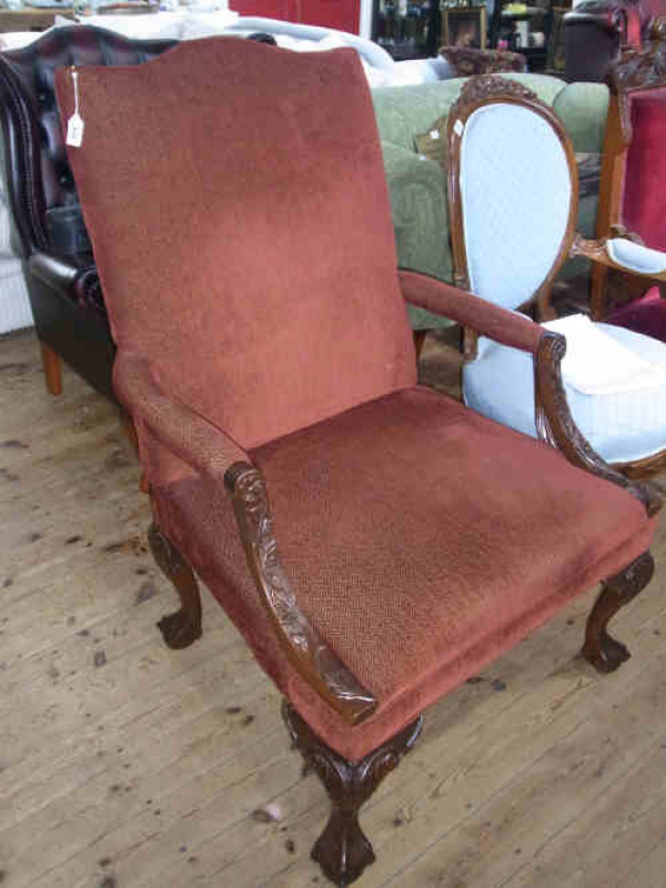 Victorian Style Carved Mahogany Arched Back Elbow Chair on ball and claw feet, in rust fabric