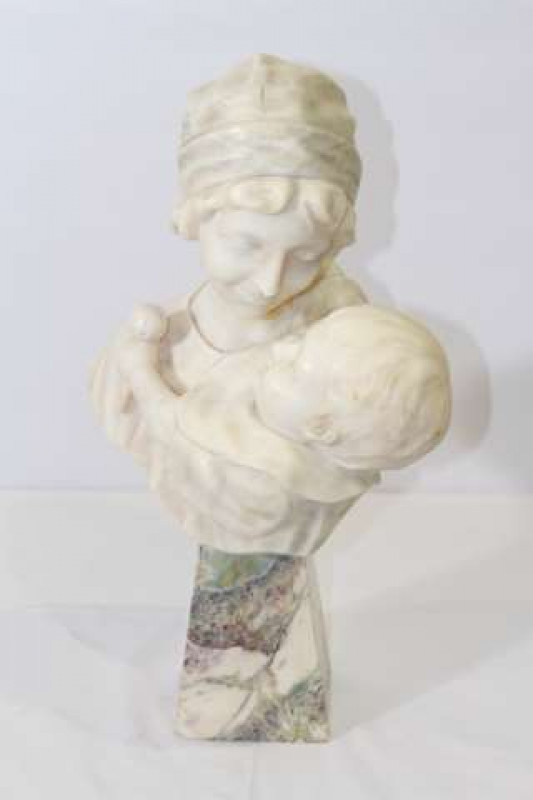 ITALIAN SCHOOL, A WHITE MARBLE BUST OF A MOTHER AND CHILD, the child carved holding a rattle, signed 'Carli', on later veined marble trapezium shaped base. 49cm
