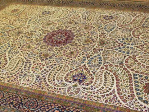 A KERMAN SILK CARPET. 383cm by 268cm