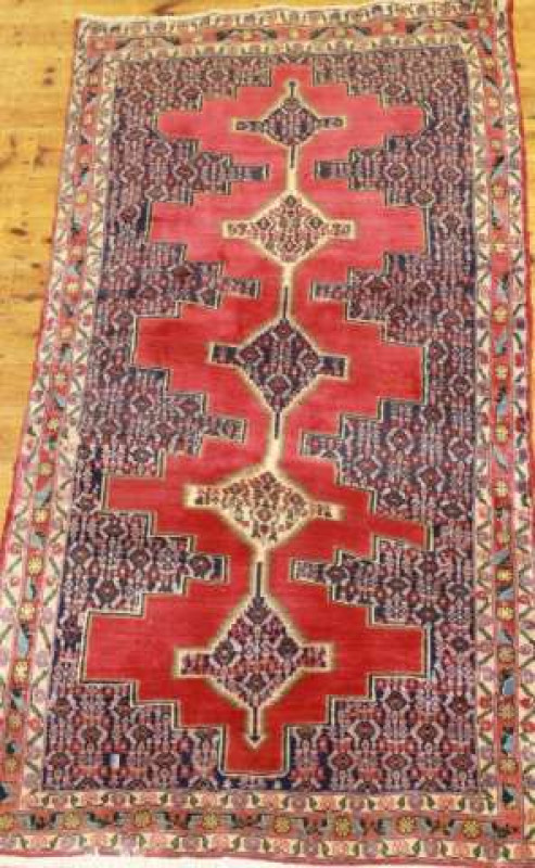 A SENNEH RUG. 179cm by 91cm