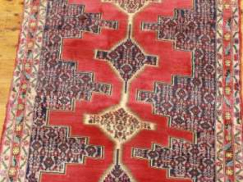 A SENNEH RUG. 179cm by 91cm