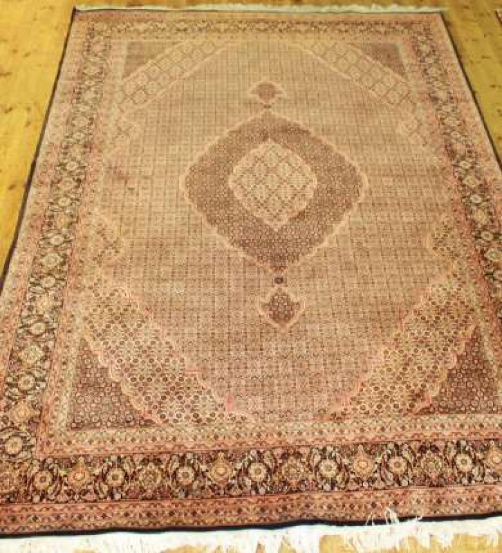 A TABRIZ CARPET, with one principal border and six smaller borders. 310cm by 200cm