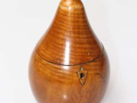 A FRUITWOOD PEAR-SHAPED TEA CADDY, with naturalistic 'stork'. 17cm