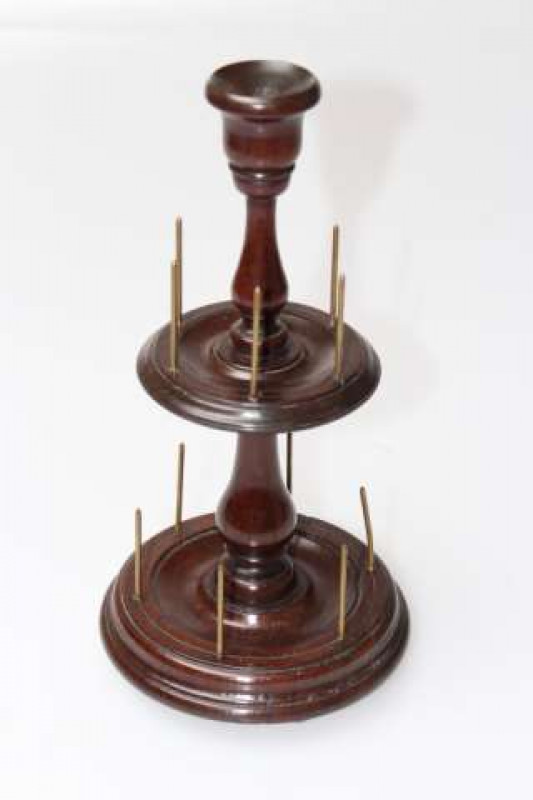 A 19TH CENTURY MAHOGANY BOBBIN STAND, with two moulded circular tiers with six holders, raised on flattened bun feet. 25cm