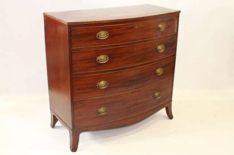 A REGENCY MAHOGANY BOW-FRONTED CHEST OF DRAWERS, the top with reeded edge, over four drawers with cockbeaded fronts, fitted with brass oval backplate handles, raised on splayed bracket feet. 107cm by 108cm by 54cm