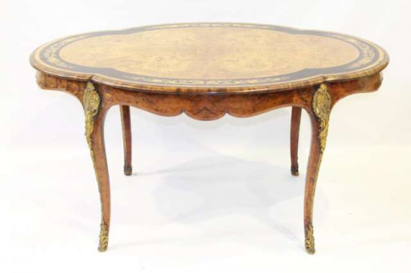 A 19TH CENTURY GILT-METAL MOUNTED WALNUT AND FLORAL MARQUETRY CENTRE TABLE, the lobed oval top with crossbanding and four inlaid bands of foliage on an ebonised ground, over a frieze drawer, raised on cabriole legs with foliate cast mounts. 72.5cm by 145c