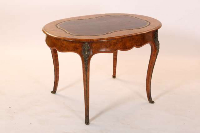 A 19TH CENTURY GILT-METAL MOUNTED, FLORAL MARQUETRY AND WALNUT BUREAU PLAT, the crossbanded and moulded oval top with gilt-tooled cartouche-shaped leather inset, over a frieze fitted with a drawer, raised on cabriole legs with foliate cast mounts. 74.5cm 