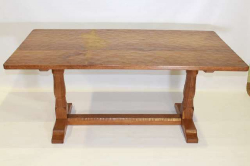 AN ALBERT 'EAGLEMAN' JEFFERIES OAK DINING SUITE, the 5'6' table with adzed rectangular top, raised on a trestle base, signed, 75cm by 168cm by 84.5cm; the four chairs with Yorkshire Rose carved back panels, signed; the dresser rack with half-penny moulded