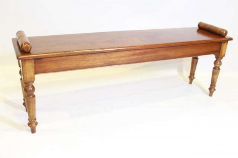A WALNUT WINDOW BENCH, raised on turned tapering legs. 137cm