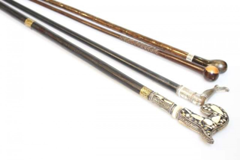 Four walking canes, including silver mounted and one inlaid