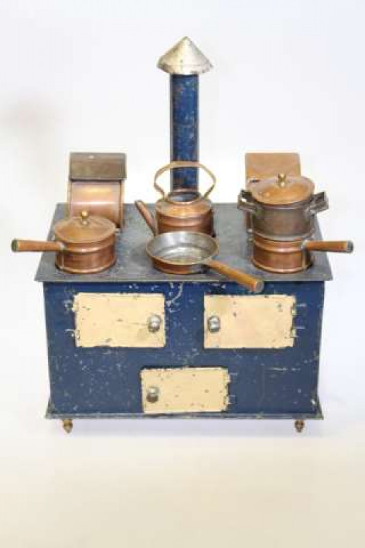 Tinplate toy cooking stove, complete with chimney and copper pans and storage bins