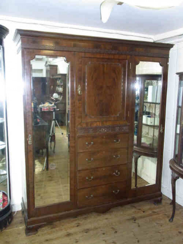 Chippendale Style Mahogany Double Mirror Door Wardrobe, with centre cupboard over drawers, and raised on ogee feet
