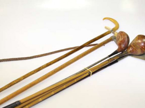 Silver mounted walking cane, riding crop and five old fashioned golf clubs