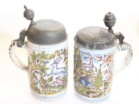 Two German polychrome decorated tin-glazed earthenware tankards, probably...