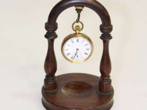 Small lady's fob watch stamped 18k, on stand