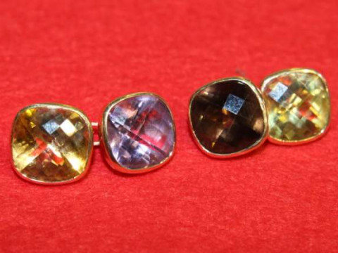 Pair of cufflinks, one set with a smoky quartz and a quartz, the other...