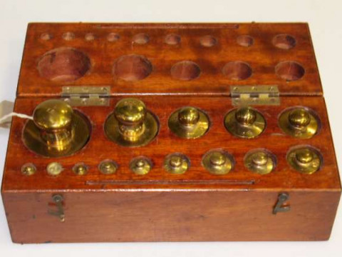 Baird & Tatlock, London, a beech cased set of scientific brass weights,...