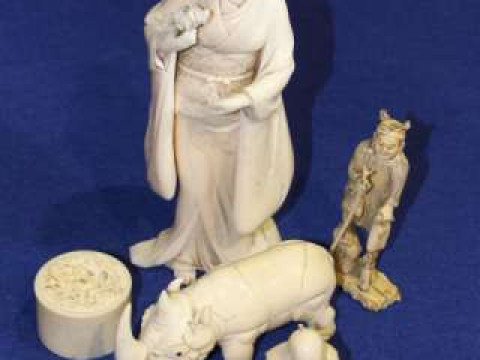 Two Japanese ivory okimonos, ivory carving of a rhino, etc (5)