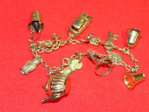 Charm bracelet with some hallmarked gold charms