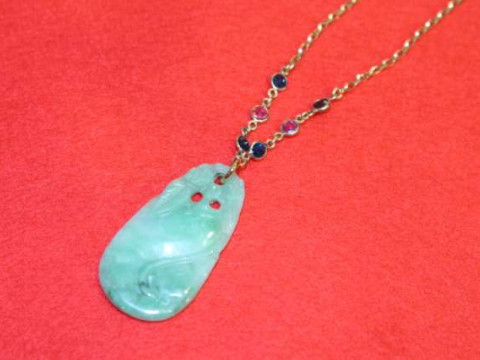 Chinese jadeite pendant, on a 9ct gold chain with six jewel spacers