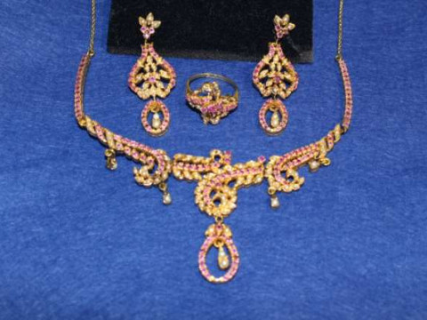 Suite of ruby and seed pearl jewellery, comprising necklace, pair of earrings...