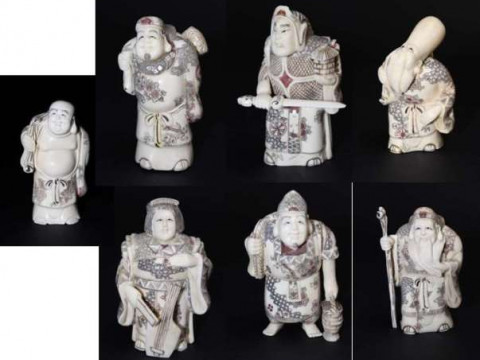 Set of seven engraved and stained bone figures on stand